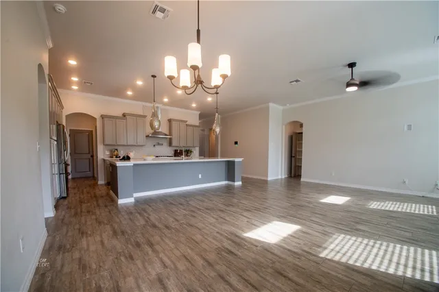 a view of a kitchen with a sink and refrigerator