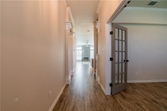 a view of a hallway with wooden floor and staircase