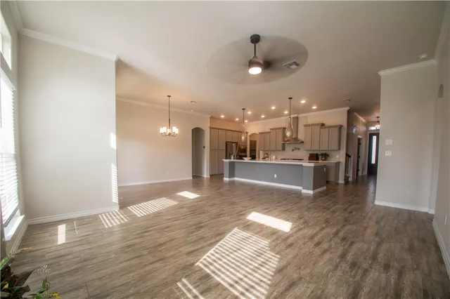a view of a living room a kitchen and a wooden floor