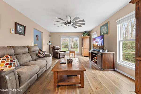 a living room with furniture a large window and a flat screen tv