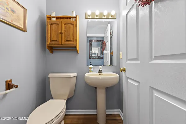 a bathroom with a toilet sink and mirror