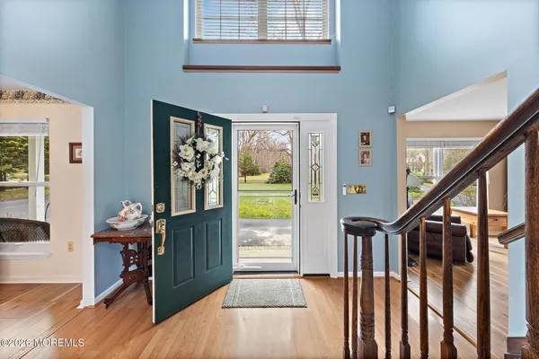 a view of a hallway with wooden floor and entryway