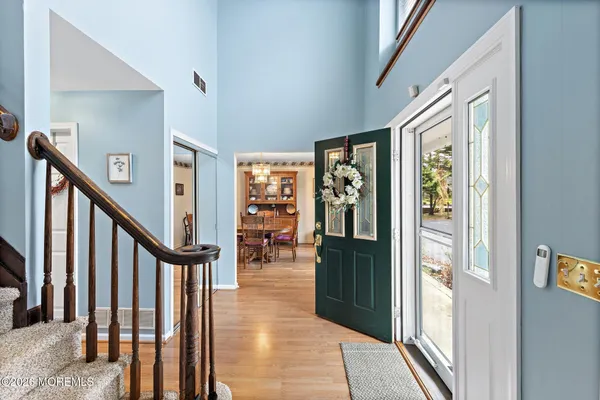 a view of a hallway with wooden floor and stairs
