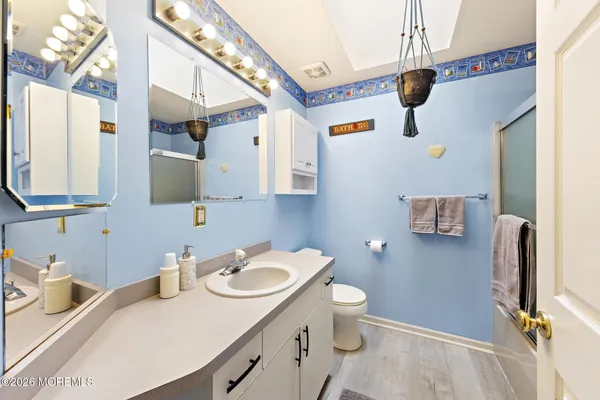 a bathroom with a tub a sink and mirror