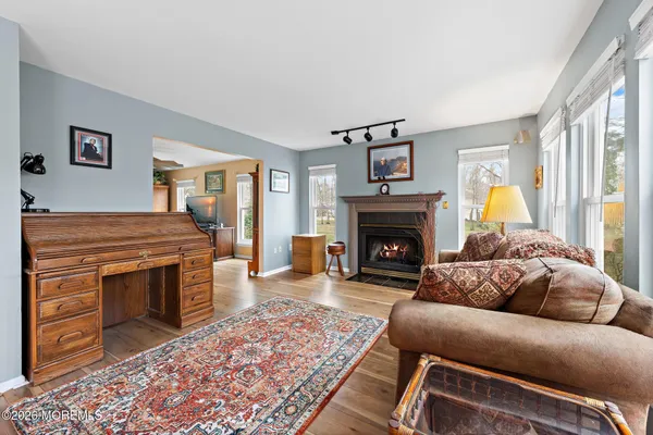 a living room with a couch a stove a fireplace and a large window