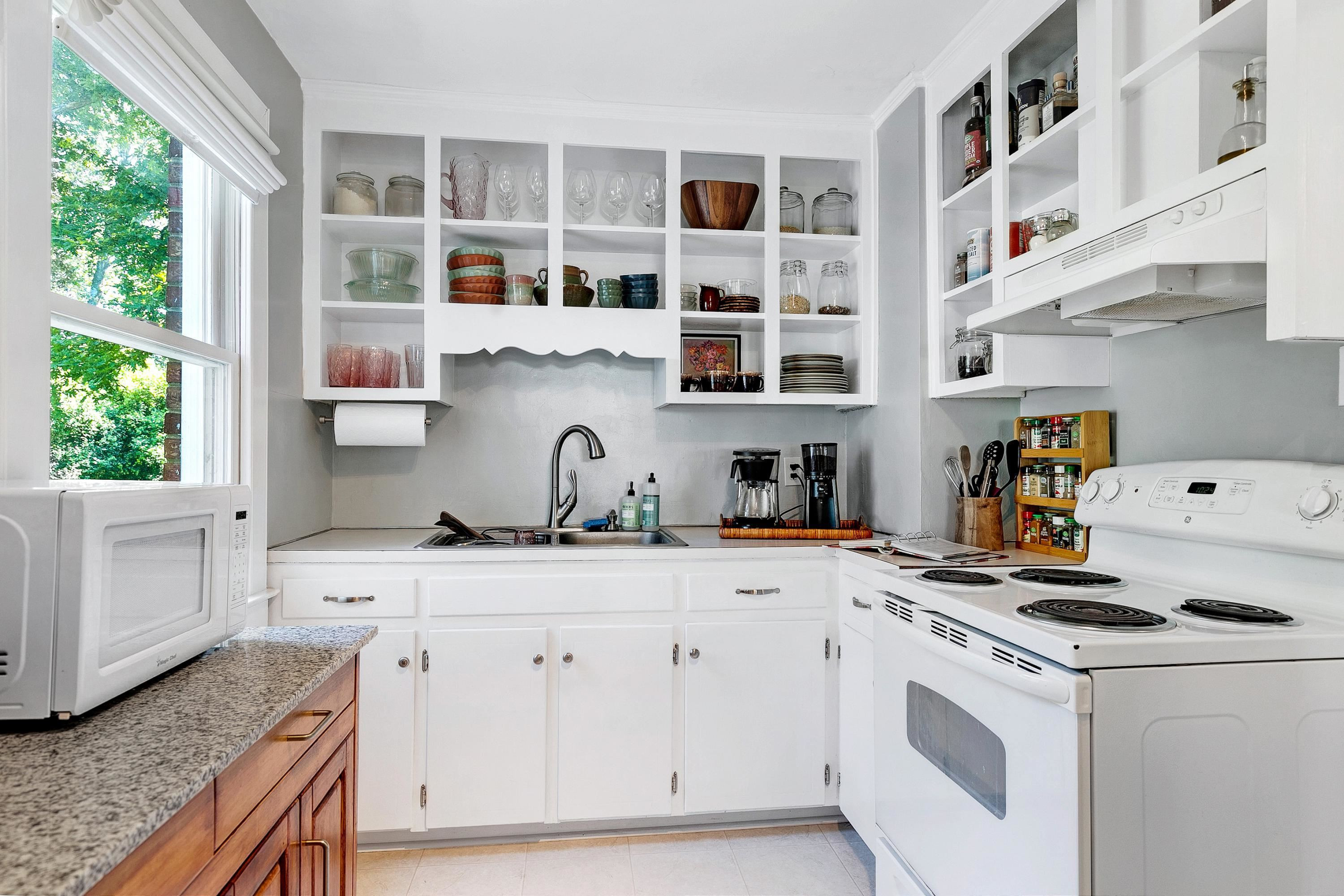 501 North King Charles Road Raleigh, NC 27610 - Photo 5 of 42 a kitchen with stainless steel appliances white cabinets and a window