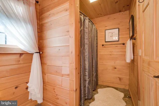 a bedroom with two beds and a chair