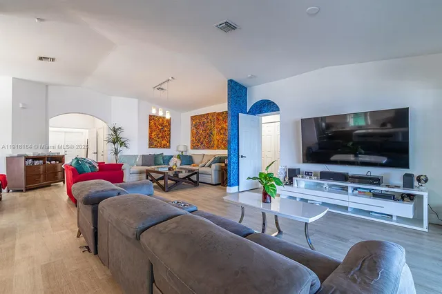 a bedroom with a bed and a lamp on dresser