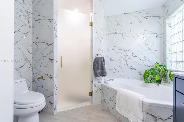 a bathroom with a sink a mirror and a toilet