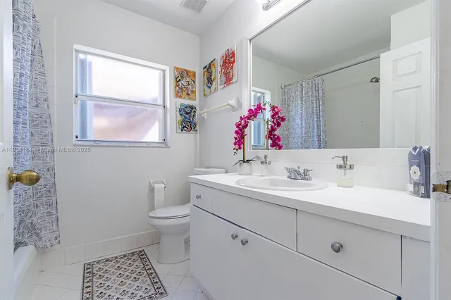 a living room with furniture rug and a large window