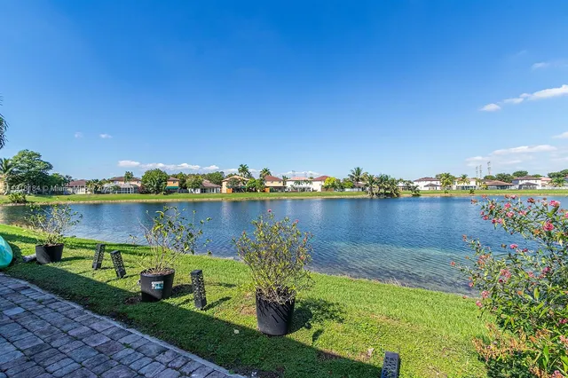 a living room with patio furniture and a potted plant