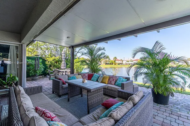 a view of a house with backyard and sitting area
