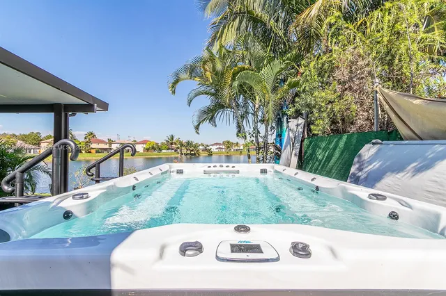 an aerial view of a city with lots of residential buildings ocean and mountain view in back