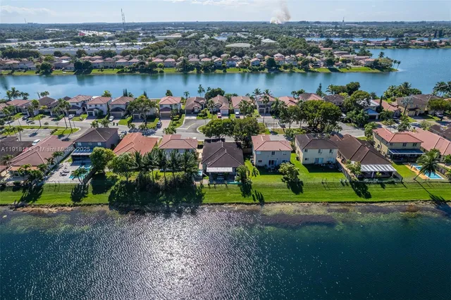 a front view of a house with a yard and potted plants