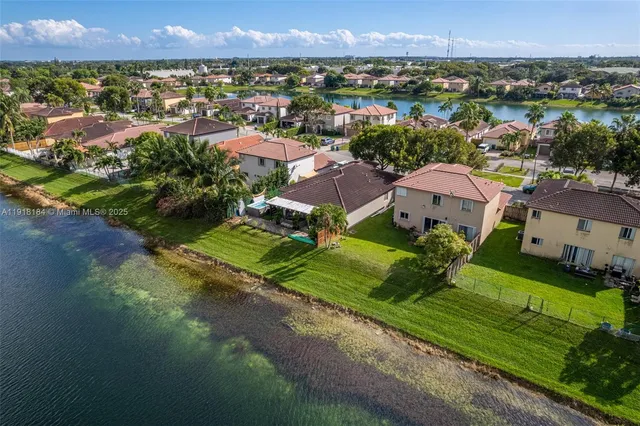 a living room with furniture a chandelier and a dining table