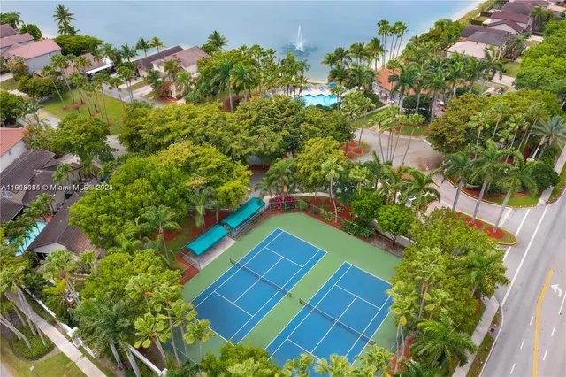 a view of a brick house with a small yard and plants