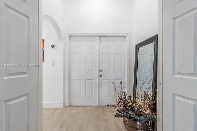 a large kitchen with kitchen island a large counter top space a sink stainless steel appliances and cabinets