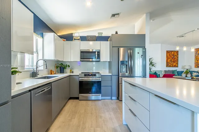 a kitchen with a refrigerator sink and stove