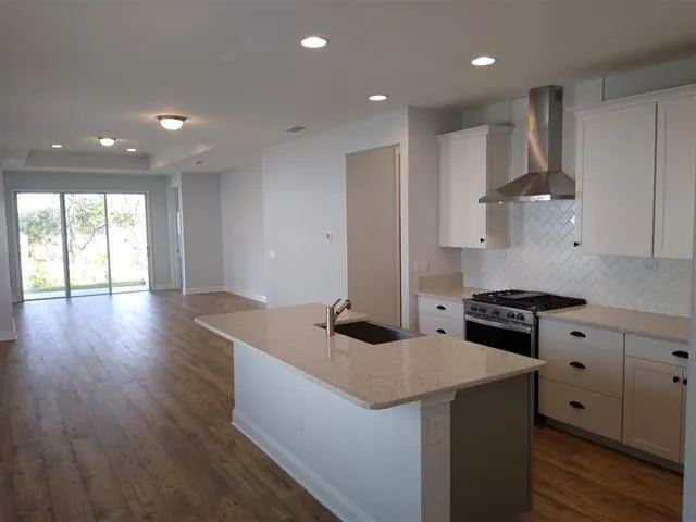a kitchen that has a sink and a stove in it