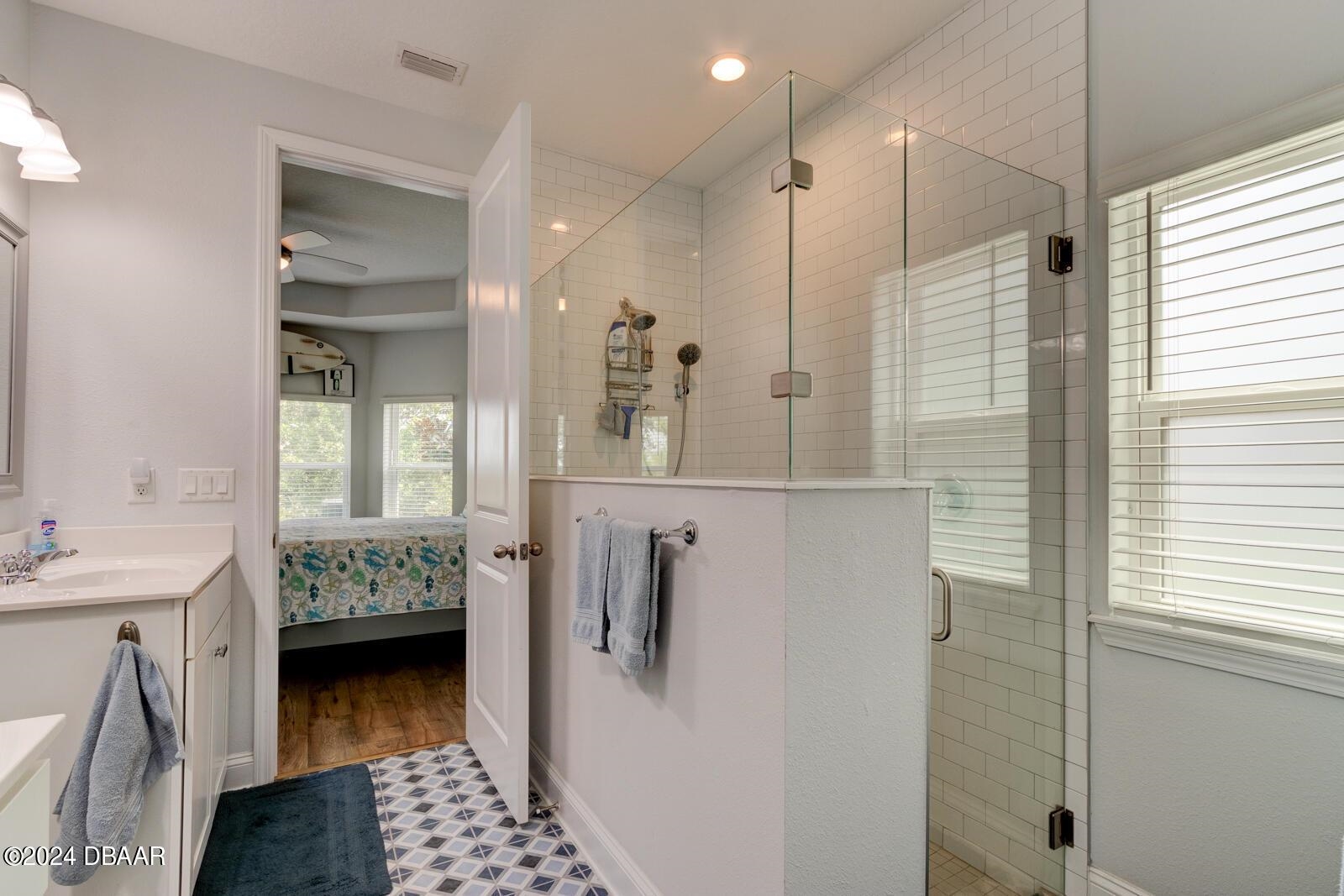 55 St Barts Avenue St. Augustine, FL 32080 - Photo 7 of 20 a bathroom with a double vanity sink a mirror and a shower