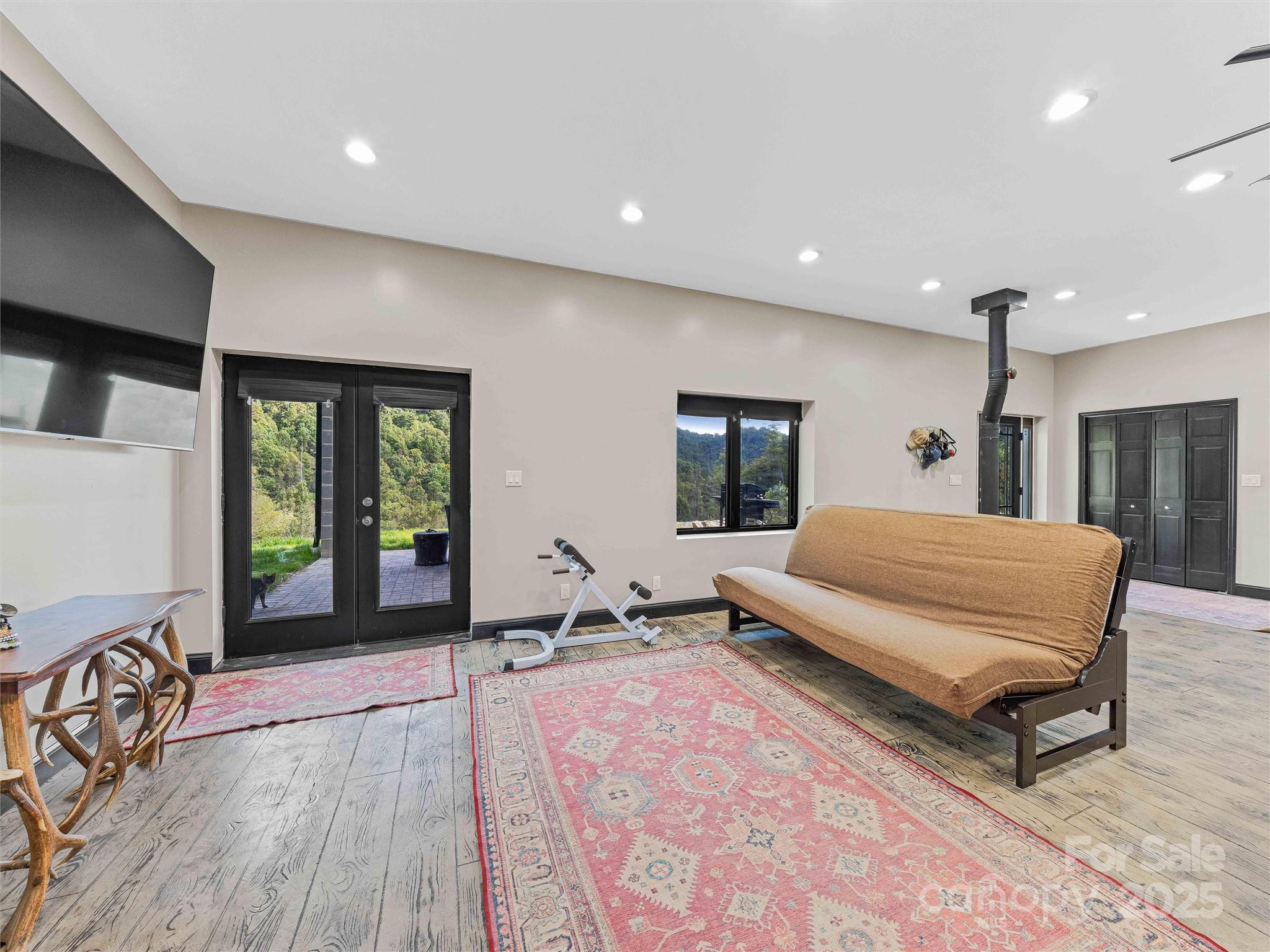 945 Roaring Fork Road Hot Springs, NC 28743 - Photo 11 of 48 a spacious bedroom with a large bed and a large window