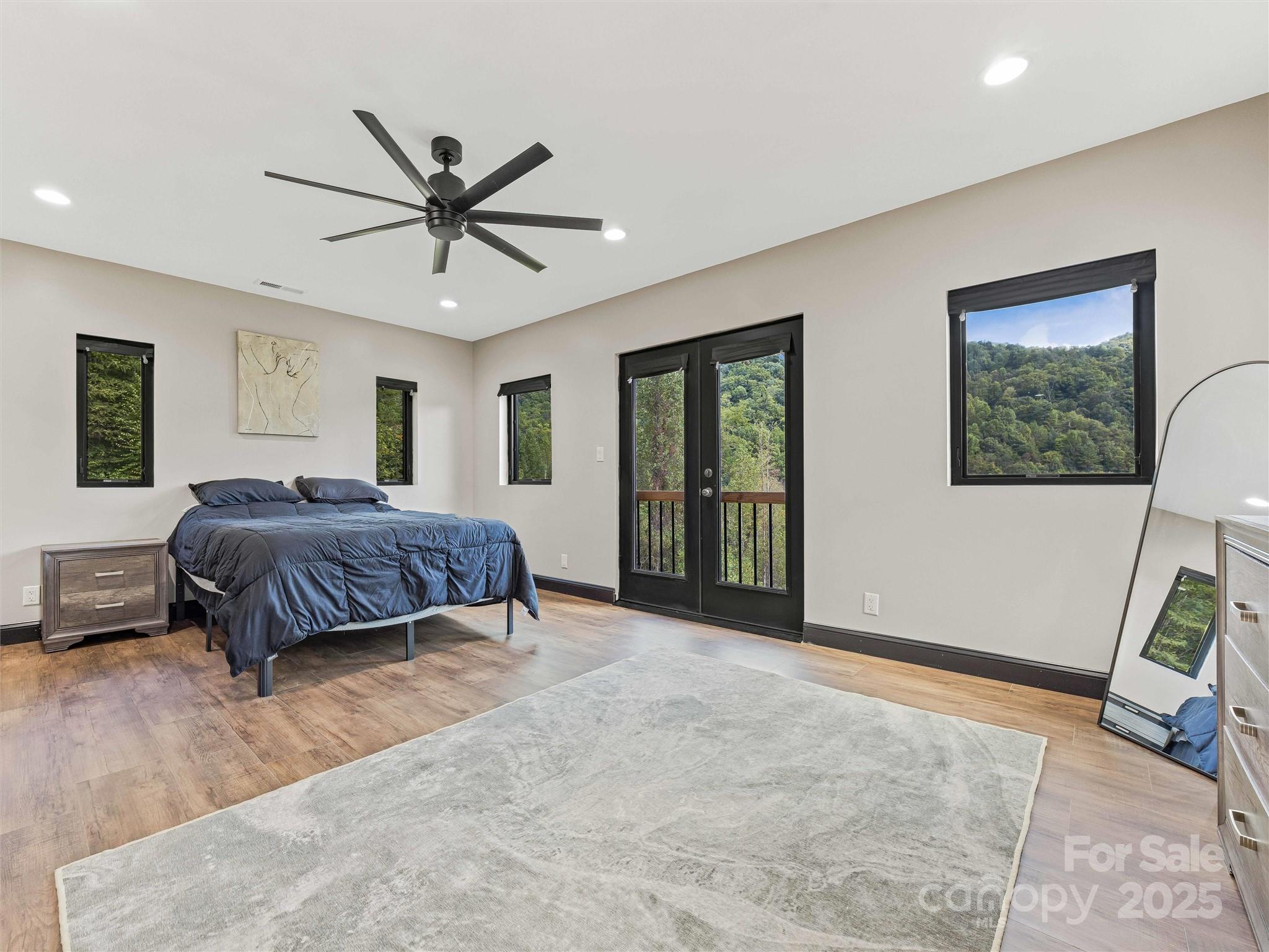 945 Roaring Fork Road Hot Springs, NC 28743 - Photo 14 of 48 a bedroom with a large bed and a window