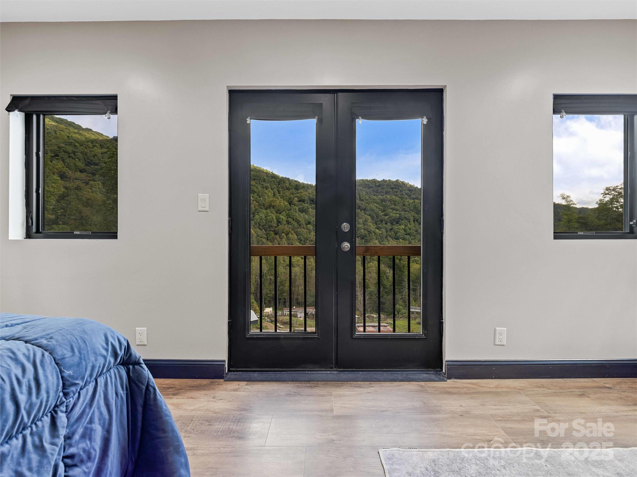 945 Roaring Fork Road Hot Springs, NC 28743 - Photo 15 of 48 a bedroom with a bed and a window
