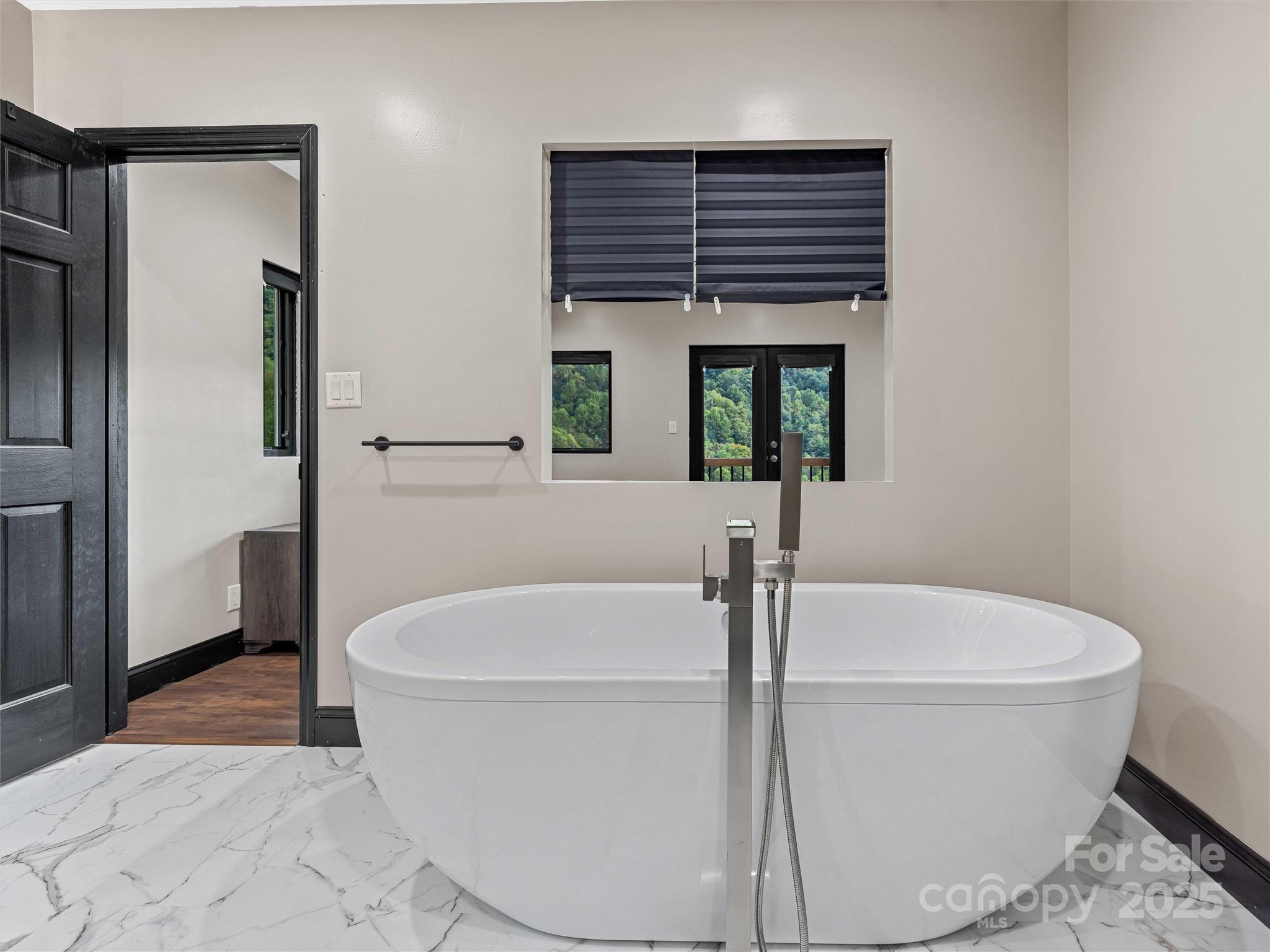 945 Roaring Fork Road Hot Springs, NC 28743 - Photo 18 of 48 a white bath tub sitting in a bathroom