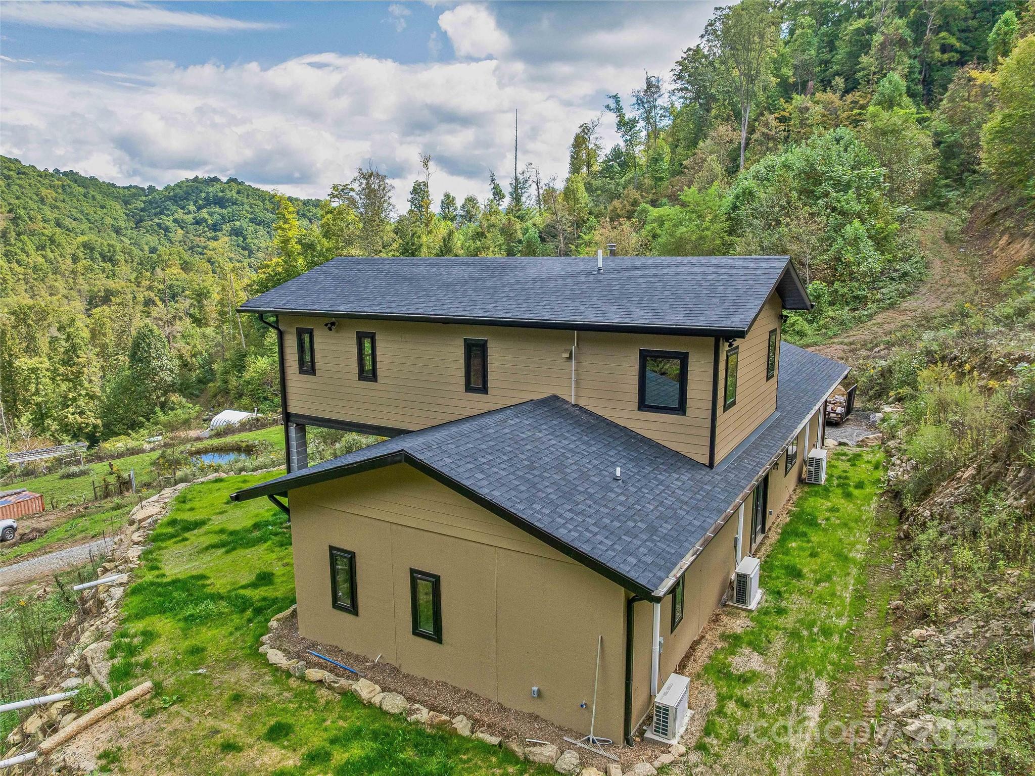 945 Roaring Fork Road Hot Springs, NC 28743 - Photo 25 of 48 a aerial view of a house with a yard plants and large tree
