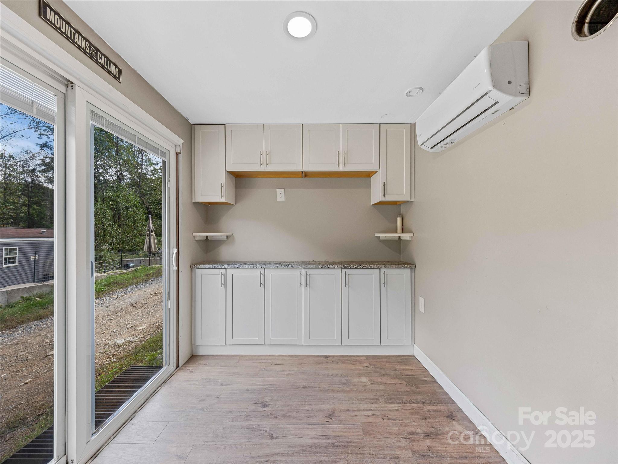 945 Roaring Fork Road Hot Springs, NC 28743 - Photo 32 of 48 a view of a kitchen with wooden floor and a window