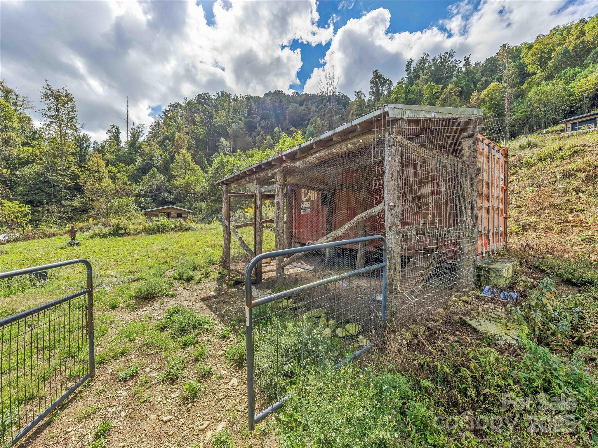 945 Roaring Fork Road Hot Springs, NC 28743 - Photo 36 of 48 a backyard of a house with lots of green space
