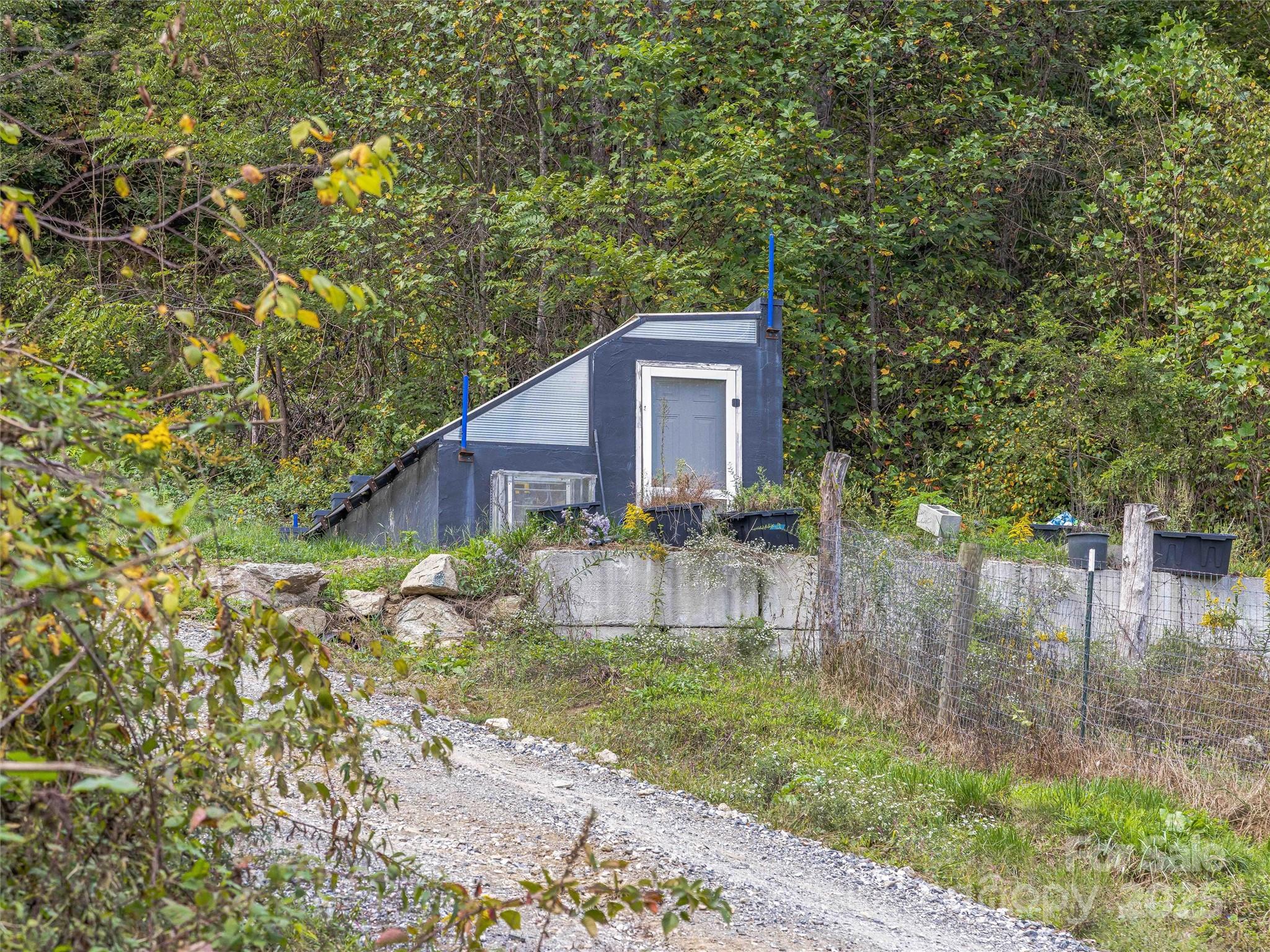 945 Roaring Fork Road Hot Springs, NC 28743 - Photo 37 of 48 a brick house with trees in front of it