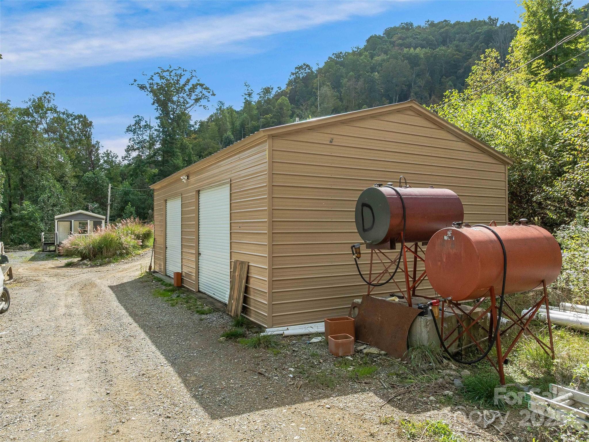945 Roaring Fork Road Hot Springs, NC 28743 - Photo 40 of 48 a view of backyard with seating space and trees