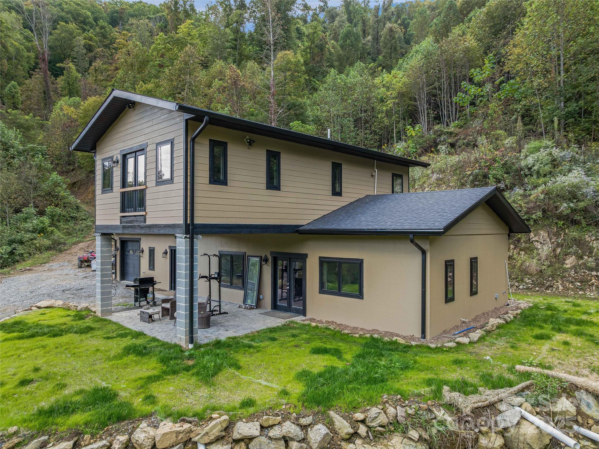 945 Roaring Fork Road Hot Springs, NC 28743 - Photo 5 of 48 a front view of a house with yard and green space