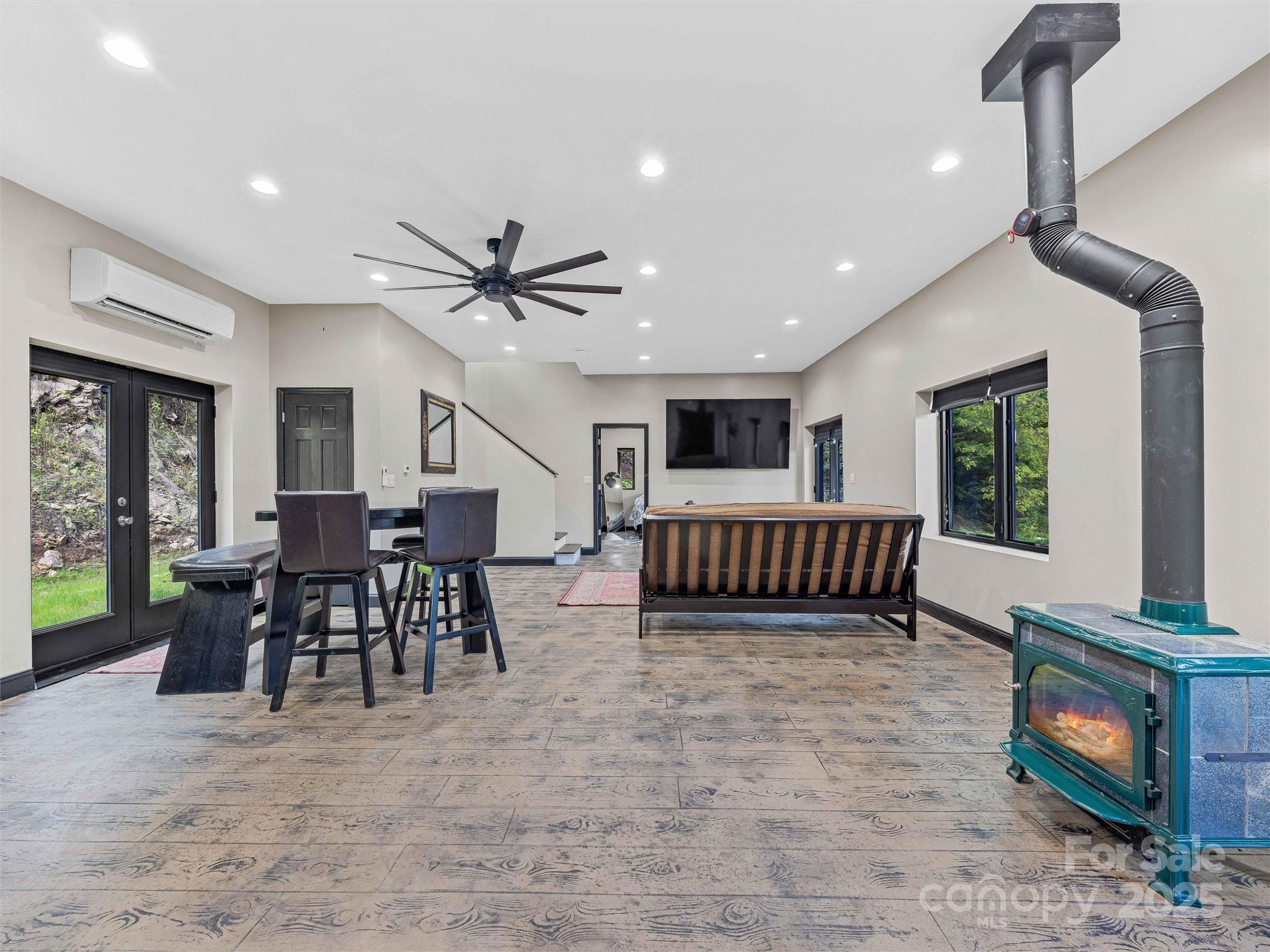 945 Roaring Fork Road Hot Springs, NC 28743 - Photo 6 of 48 a view of a livingroom with furniture and a ceiling fan