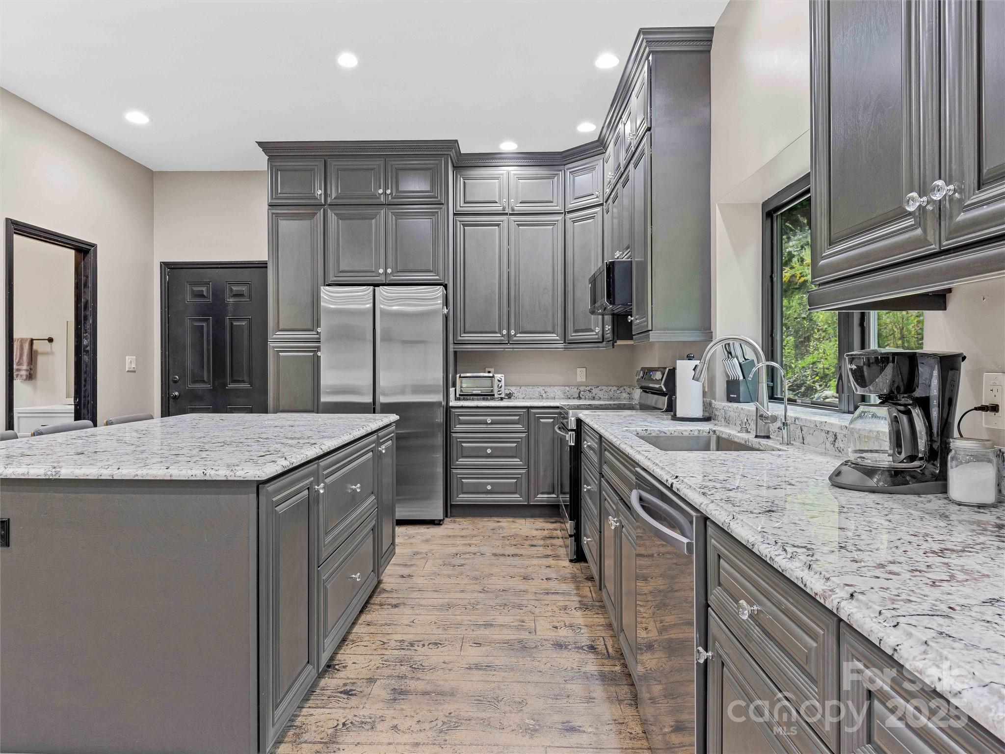 945 Roaring Fork Road Hot Springs, NC 28743 - Photo 8 of 48 a kitchen with stainless steel appliances granite countertop a sink stove and cabinets