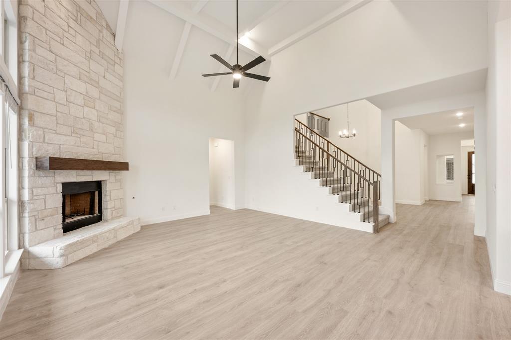 2824 Spg Vly Way Anna, TX 75409 - Photo 16 of 40 a view of an empty room with wooden floor fireplace and a window