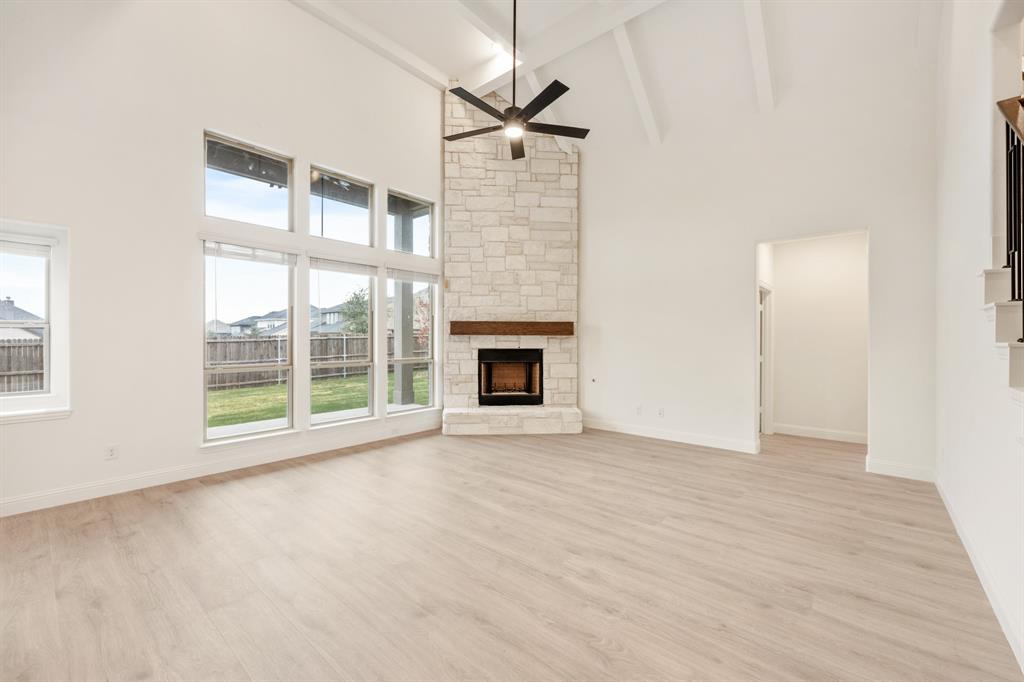 2824 Spg Vly Way Anna, TX 75409 - Photo 17 of 40 a view of an empty room with a fireplace and a window
