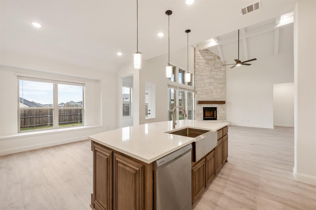 2824 Spg Vly Way Anna, TX 75409 - Photo 22 of 40 a kitchen with stainless steel appliances granite countertop a stove and kitchen island