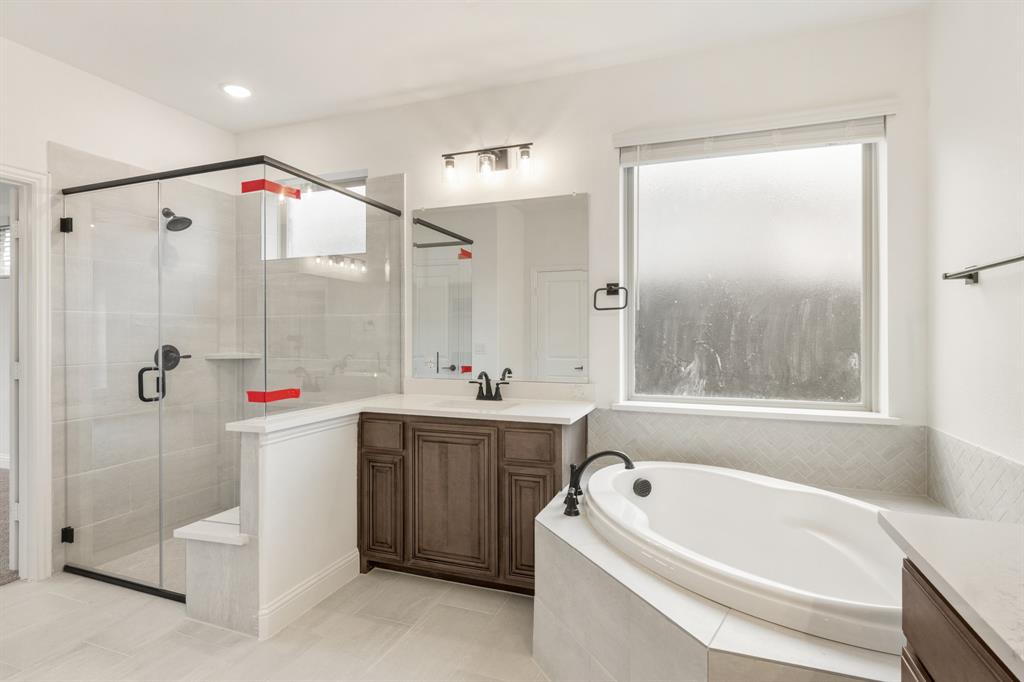 2824 Spg Vly Way Anna, TX 75409 - Photo 27 of 40 a bathroom with a tub a sink and a shower