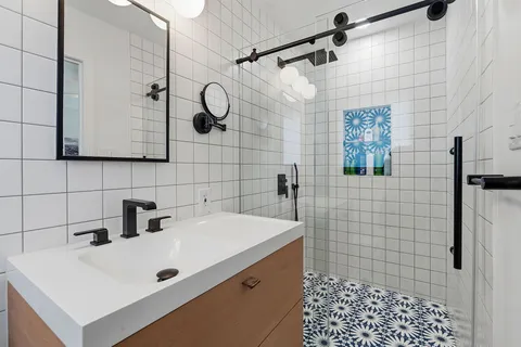 a bathroom with a sink a toilet and shower