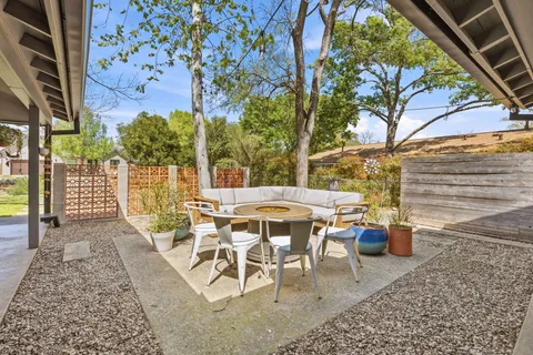 a view of a patio with table and chairs and potted plants