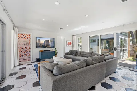a living room with furniture and a floor to ceiling window