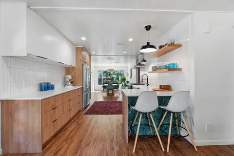 a kitchen with a stove a sink and a refrigerator