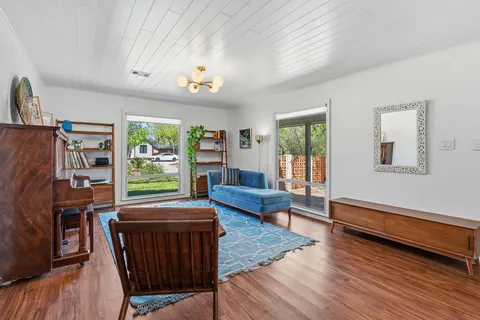 a kitchen with stainless steel appliances granite countertop a refrigerator a stove a sink dishwasher and a refrigerator with wooden floor