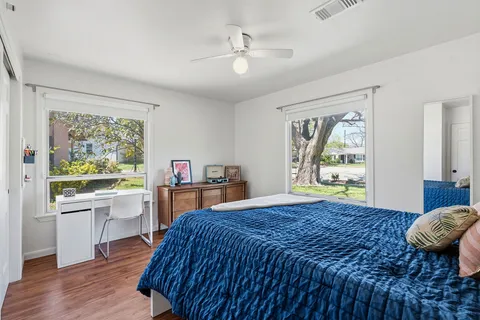 a bedroom with a bed and a painting on the wall