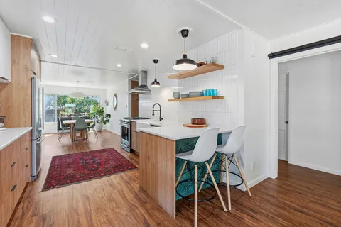 a view of a dining room with furniture wooden floor and a chandelier