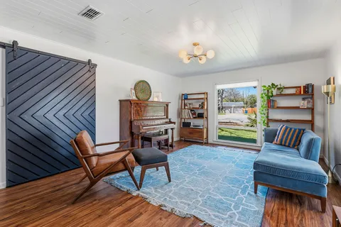 a living room with furniture and a wooden floor