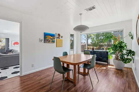 a view of a dining room with furniture window and wooden floor