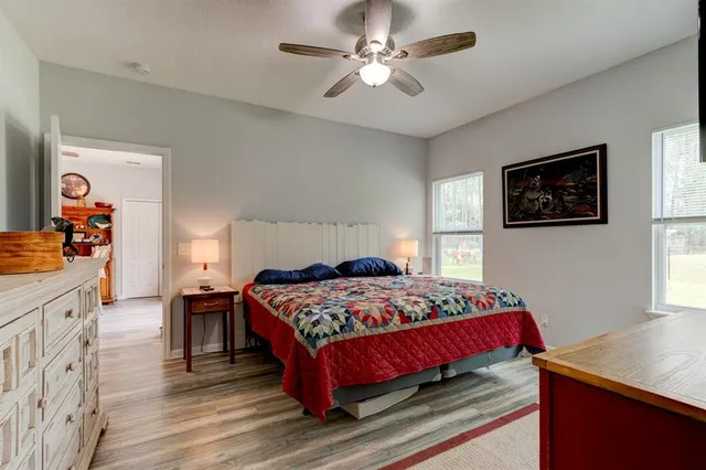 a bedroom with a bed a dresser and a window